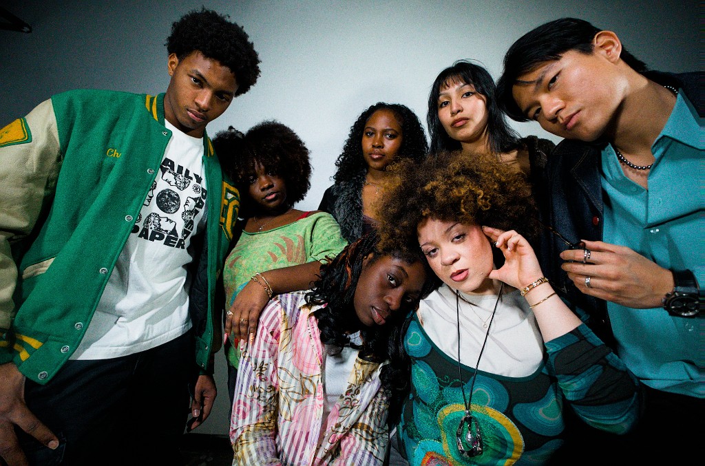 A group of friends in thrifted outfits